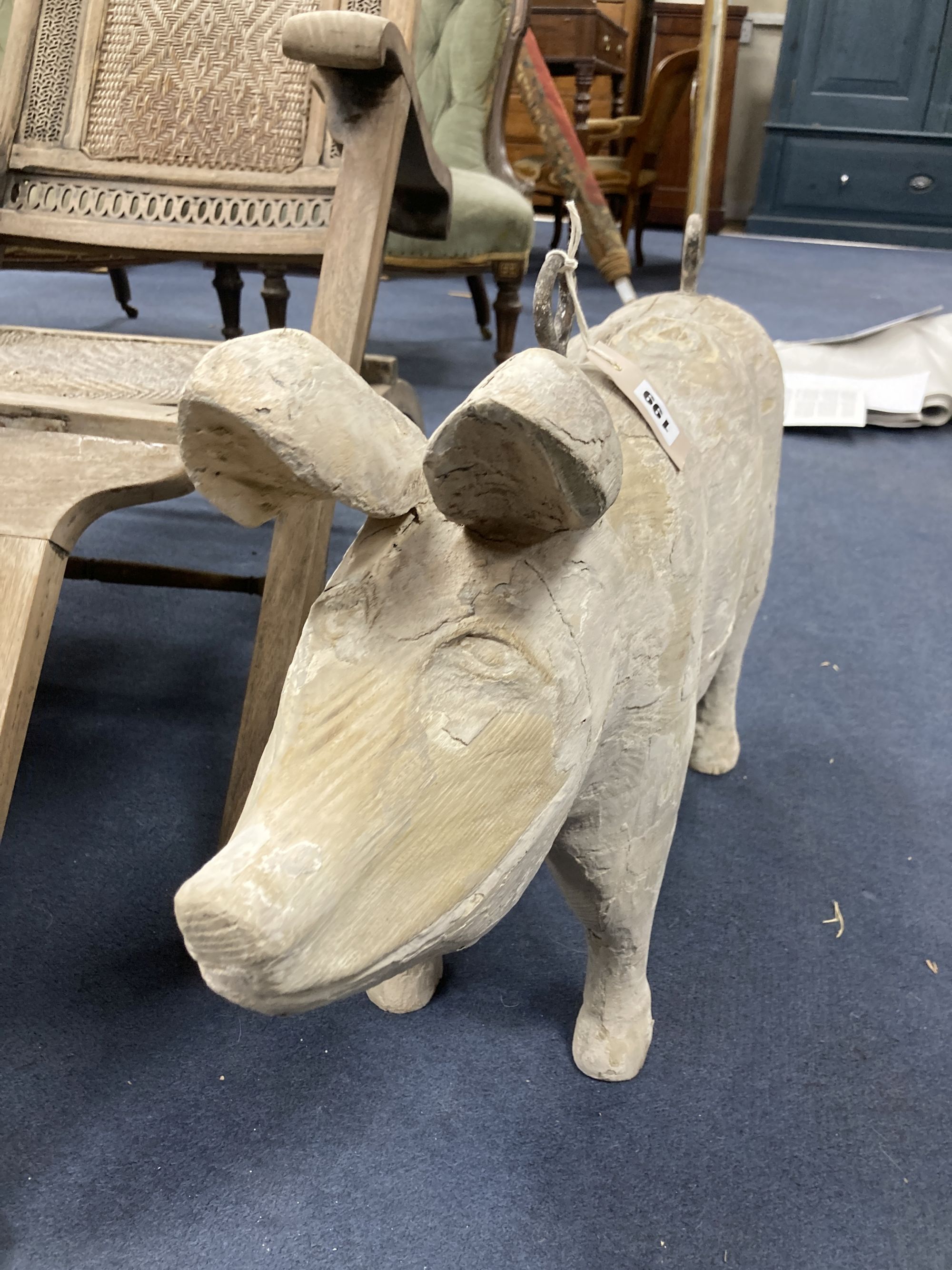 A carved wood butchers shop model of a pig, length 76cm